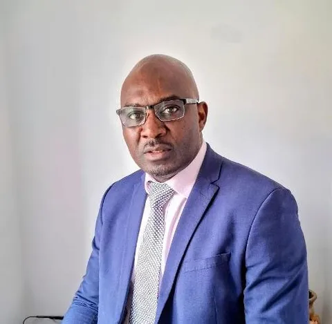 Dr Maurice Beseng looks at camera