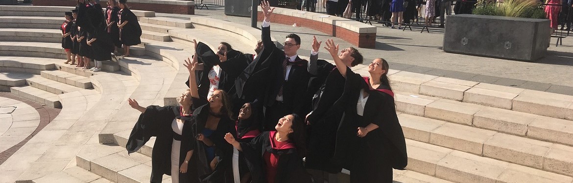 2019 Liberal Arts Graduates throwing hats in the air
