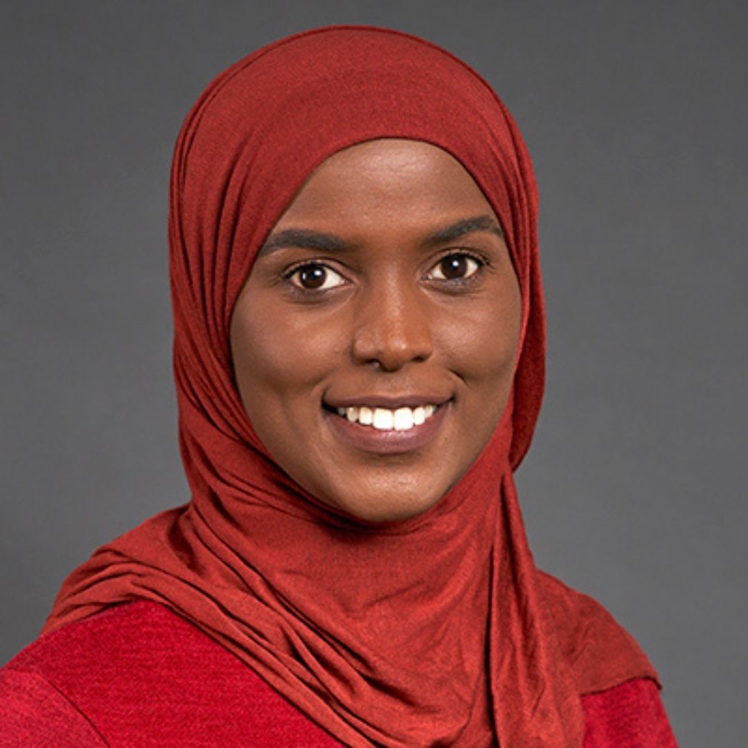 Vegetables, specifically red and yellow peppers, with a hand reaching for one