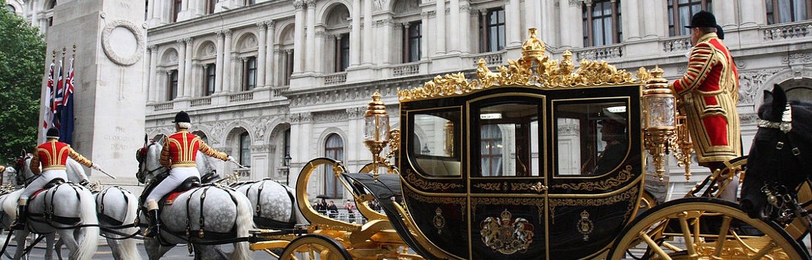 The Queen passes the Foreign & Commonwealth Office in a State coach to the Palace of Westminster for the State Opening of Parliament, 4 June 2014.