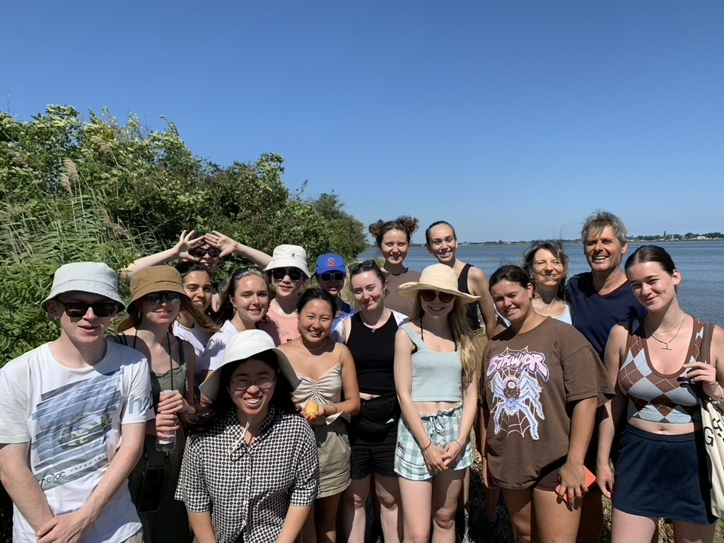Group photo of staff and students at the garden island of Sant’Erasmo. Trees and the lagoon can be seen in the background.