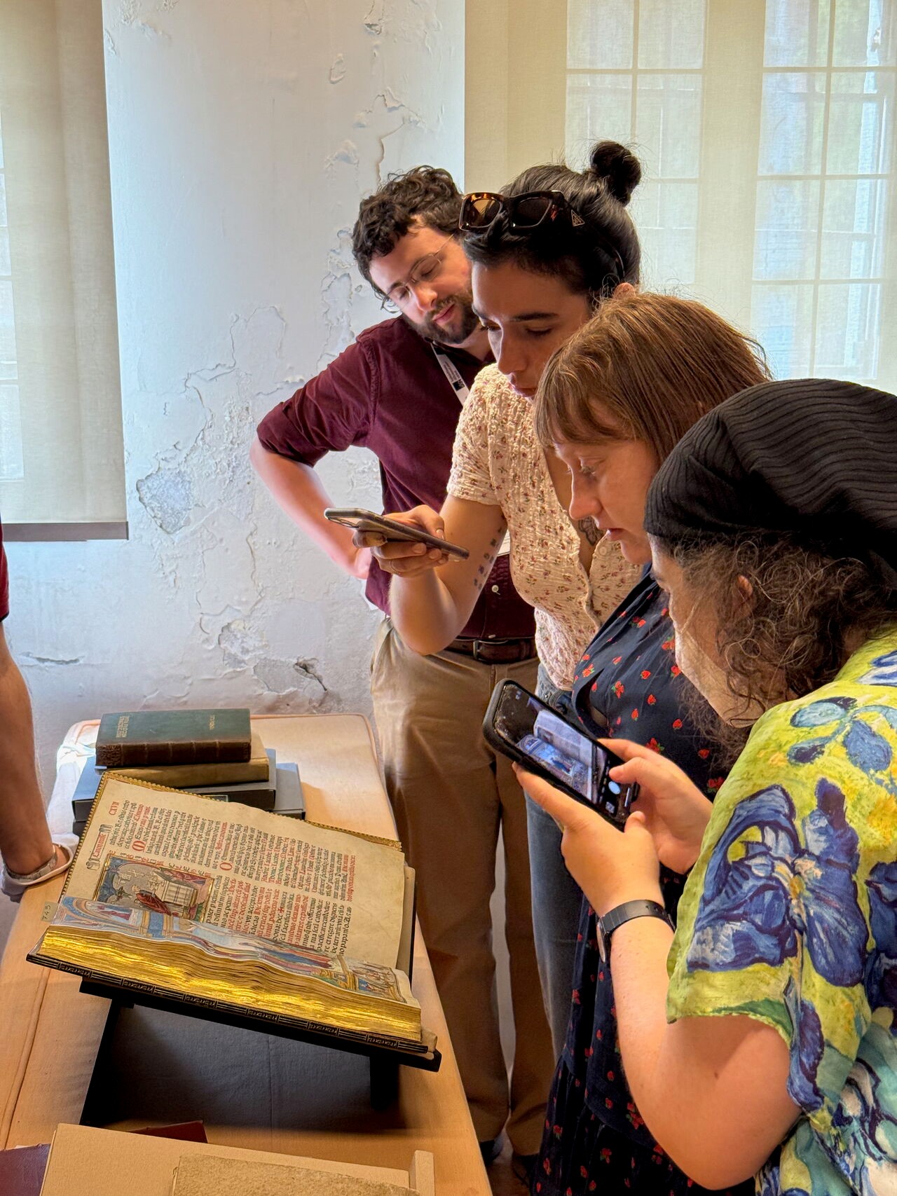 Students observe and take images of ancient book artefact within museum