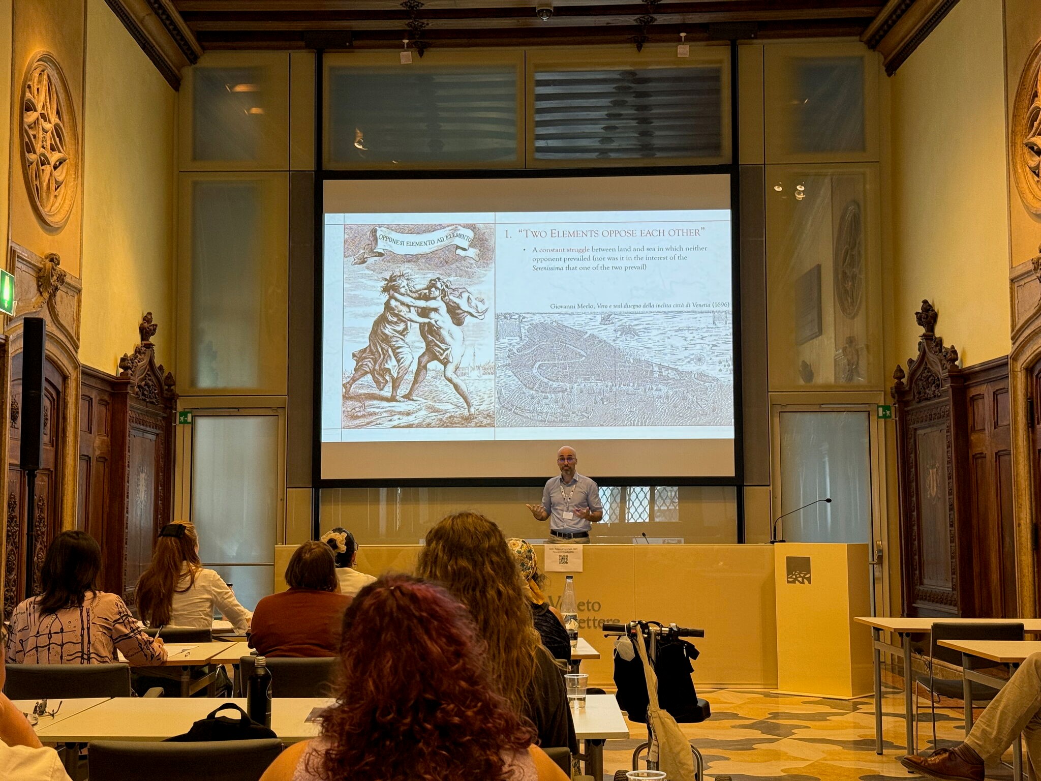 Professor presents slideshow to audience