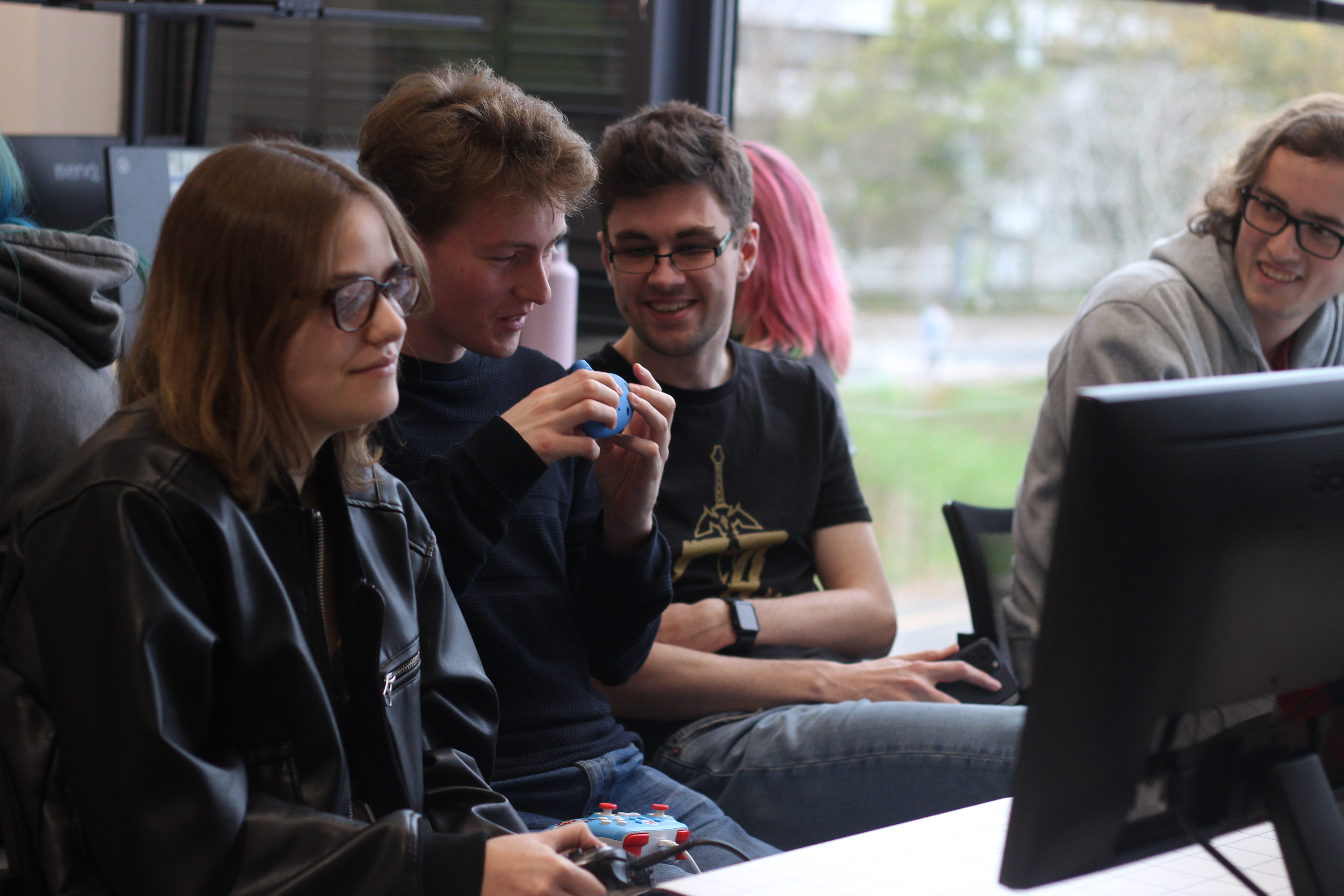 Students smiling as they play computer game