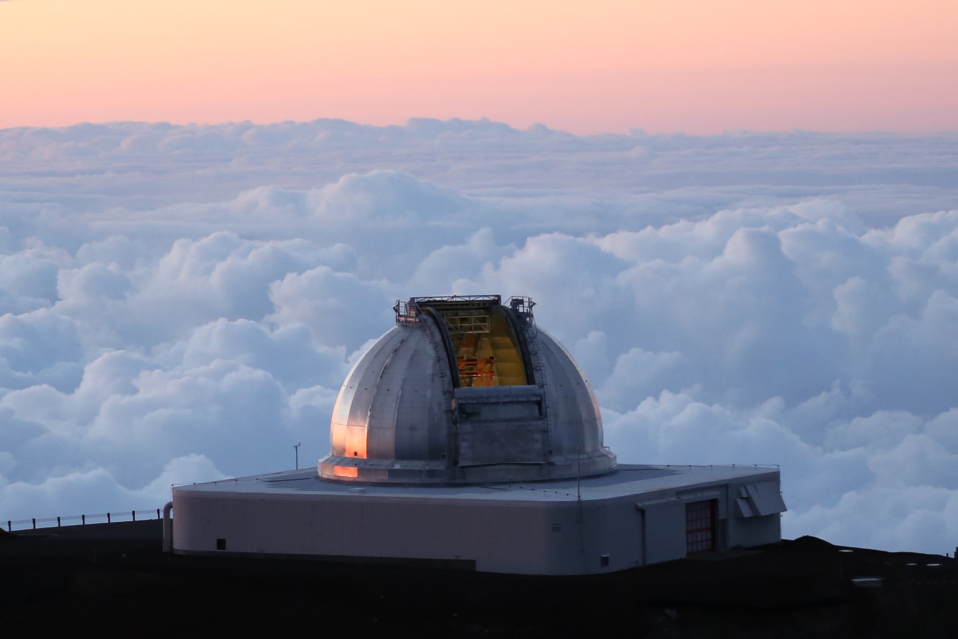 Photo of an observatory against a background of clouds