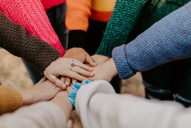 people joining hands together