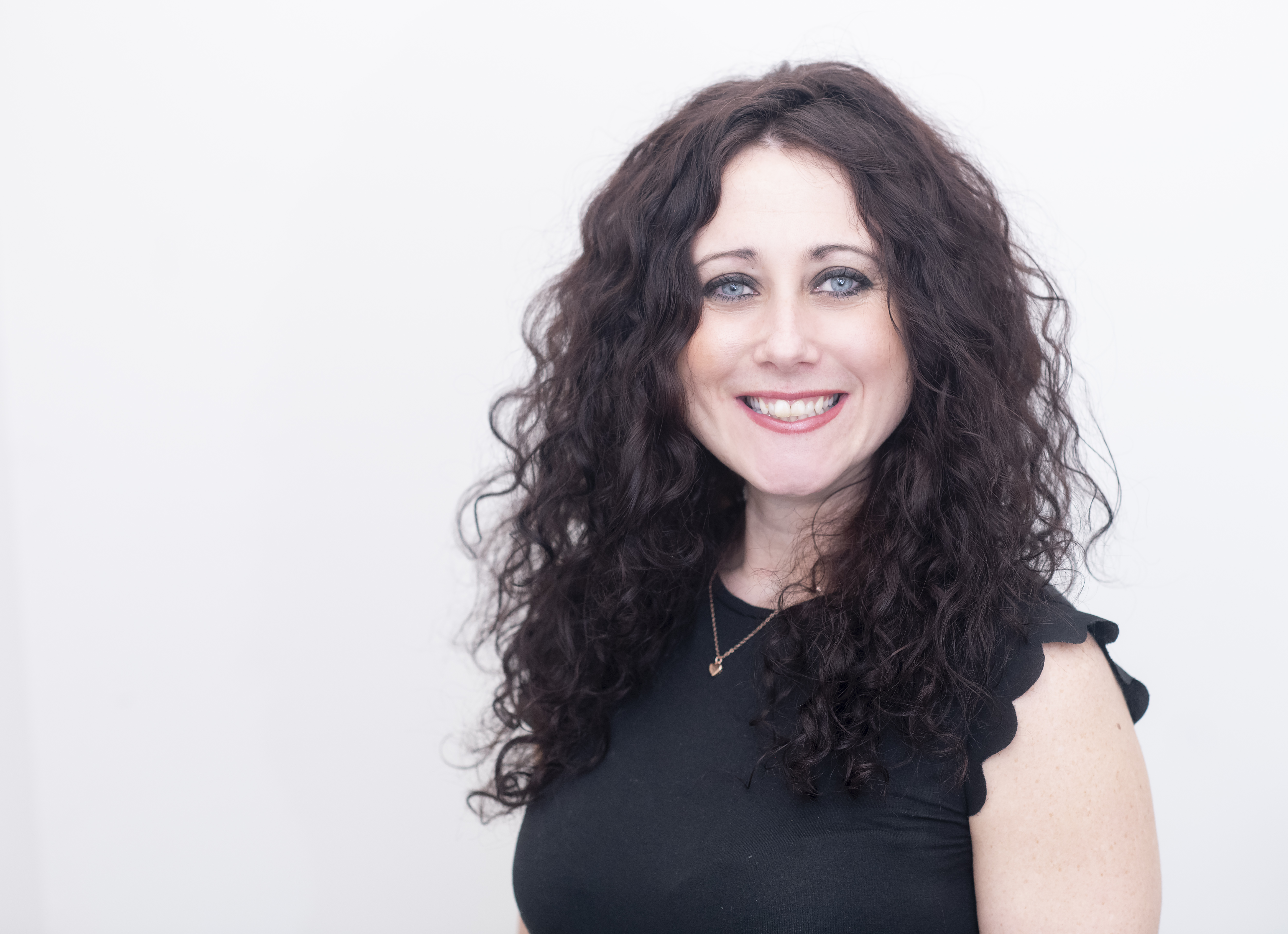 Image of Emily with long brown curly hair