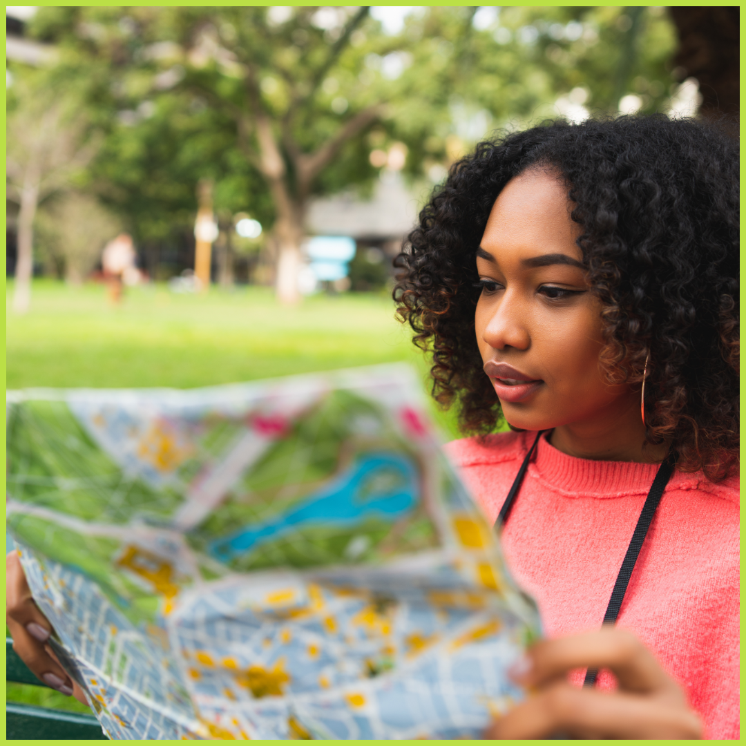 A racialised woman looking at a map