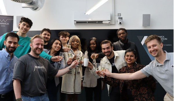 several students raising a glass for a photo