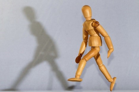 Wooden mannequin in a walking pose