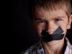 Boy with black tape over his mouth