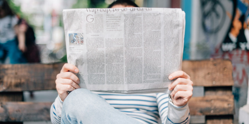 Man reading behind a newspaper