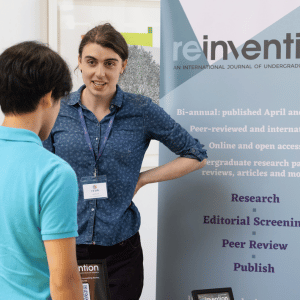Jess the Asst. Editor discussing reinvention with a student