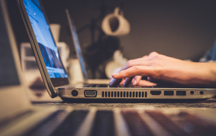 Hands on a laptop keyboard