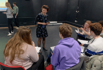 Teacher and students in large room