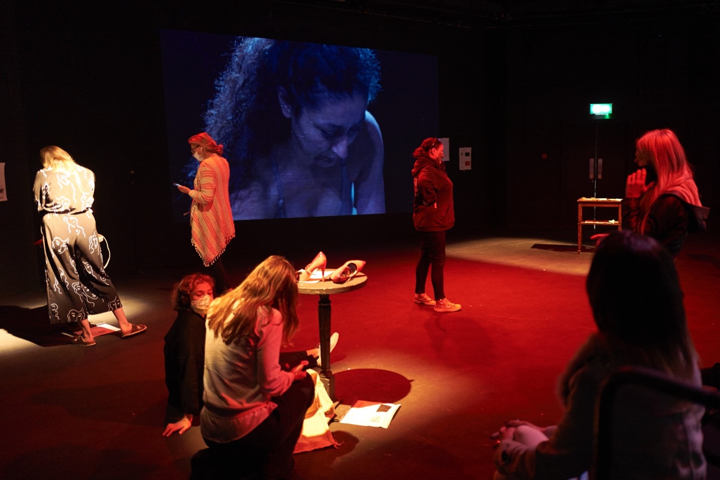 Audience looking at objects and film