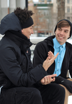 Two men talking outside