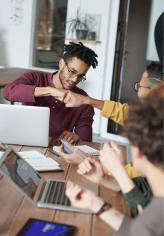 People in a meeting fist bumping