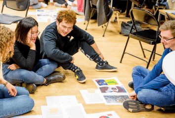 Four students sitting on the floor