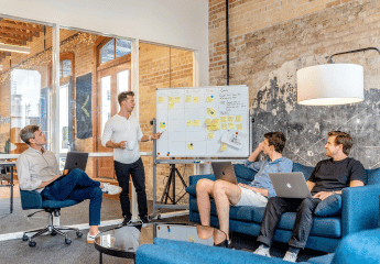 People sitting around a white board