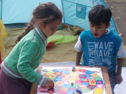 Image 1: The collaborative board game used in the study (the children in the picture are unrelated to the study). (Author's own image.)