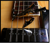 Figure 1: Illustrating how Brown may attach foreign objects such alligator clips to the strings of his guitar. Image by David Brown, reproduced with permission.