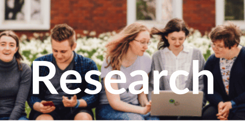 FIve students looking at at laptop outside and the text 'Research'