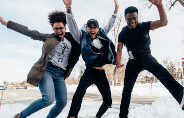 Three students jumping