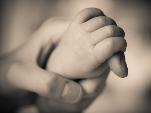 Holding baby's hand