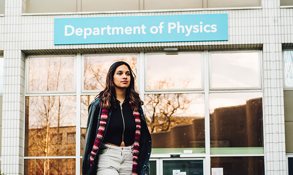A female student walks past the entrance to the Department of Physica at the University of Warwick