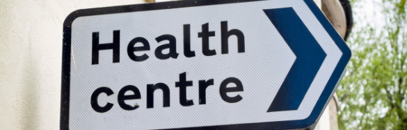 A sign pointing to health centre