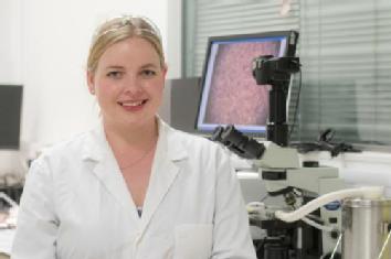 Photograph taken for the RSC Horizon Prize, it shows Caroline sat with her microscope in her lab