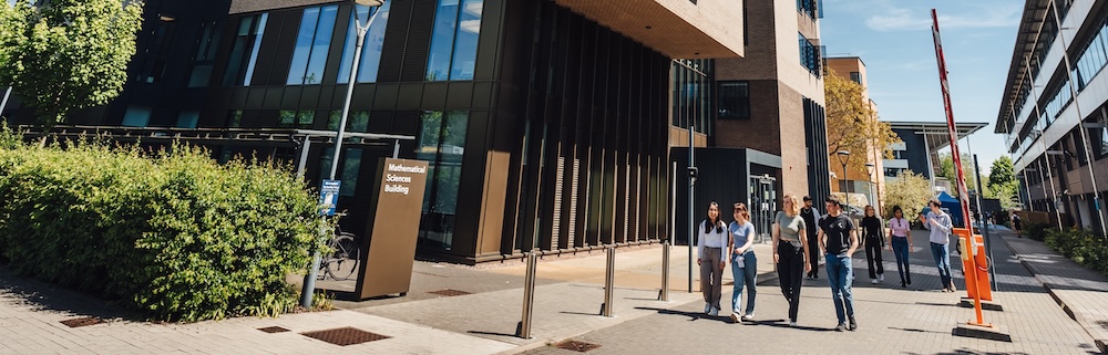 Students walking past the Mathematical Sciences Building.