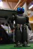 A small humanoid robot stands to attention.