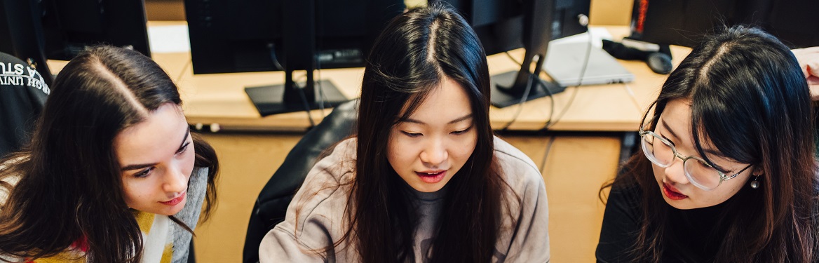 students looking at computer