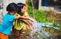 Children playing in stream of water