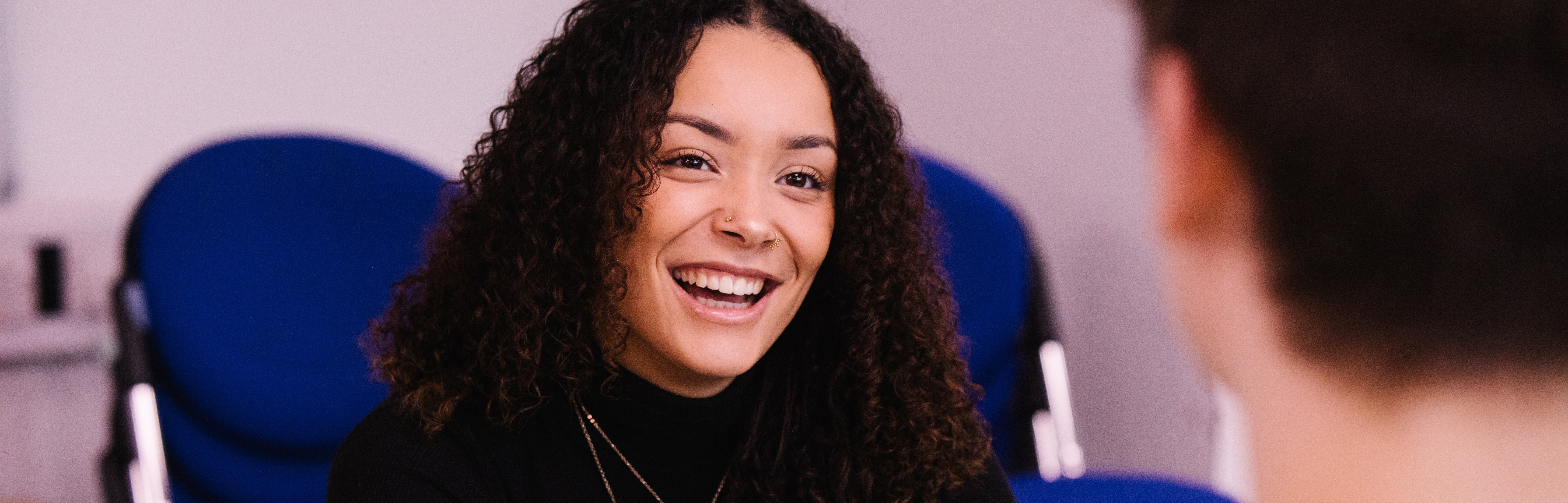 Female student smiling at fellow student