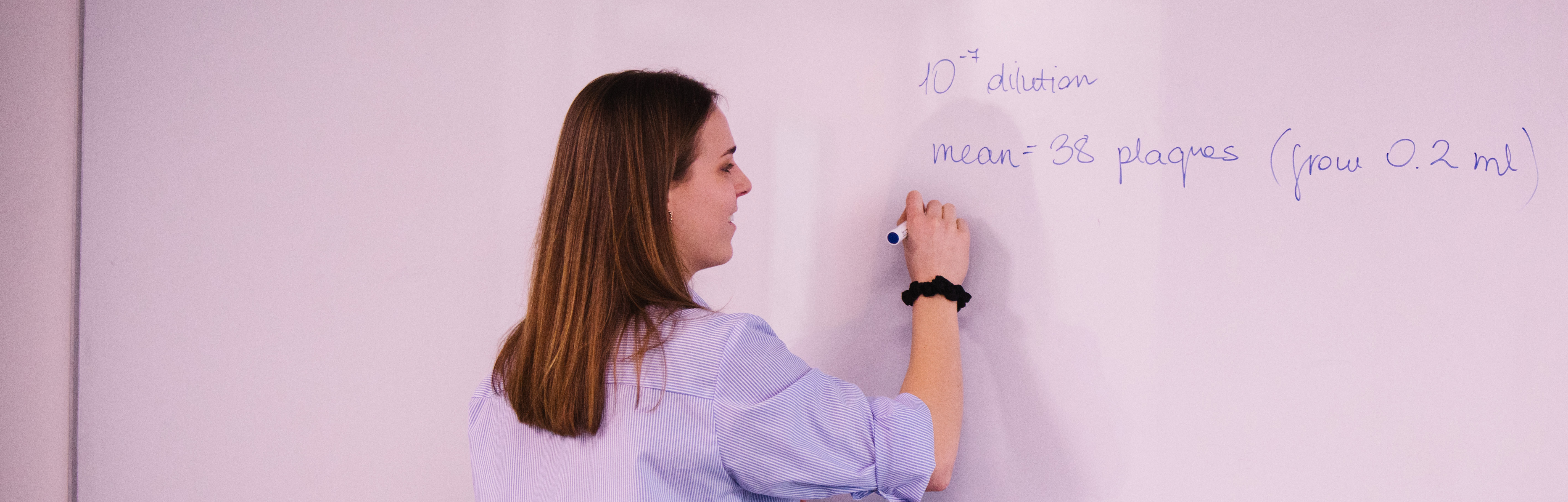 Student writing on whiteboard