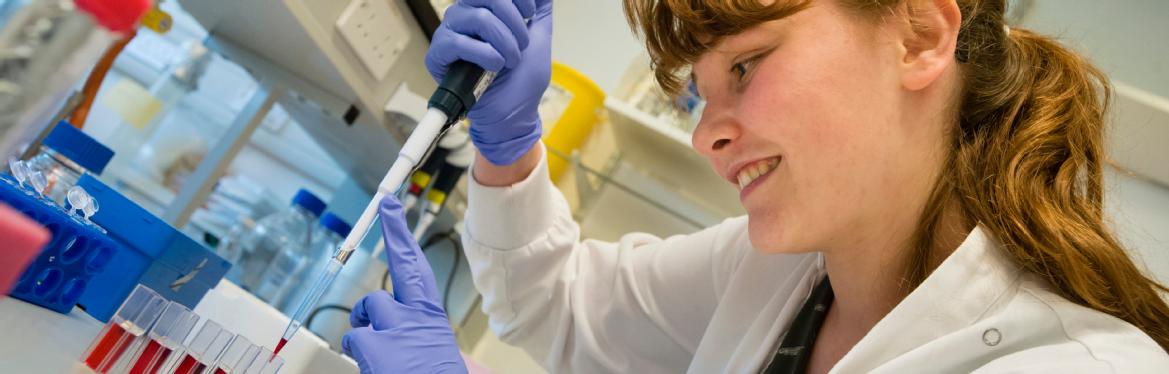 Student researcher using a pipette