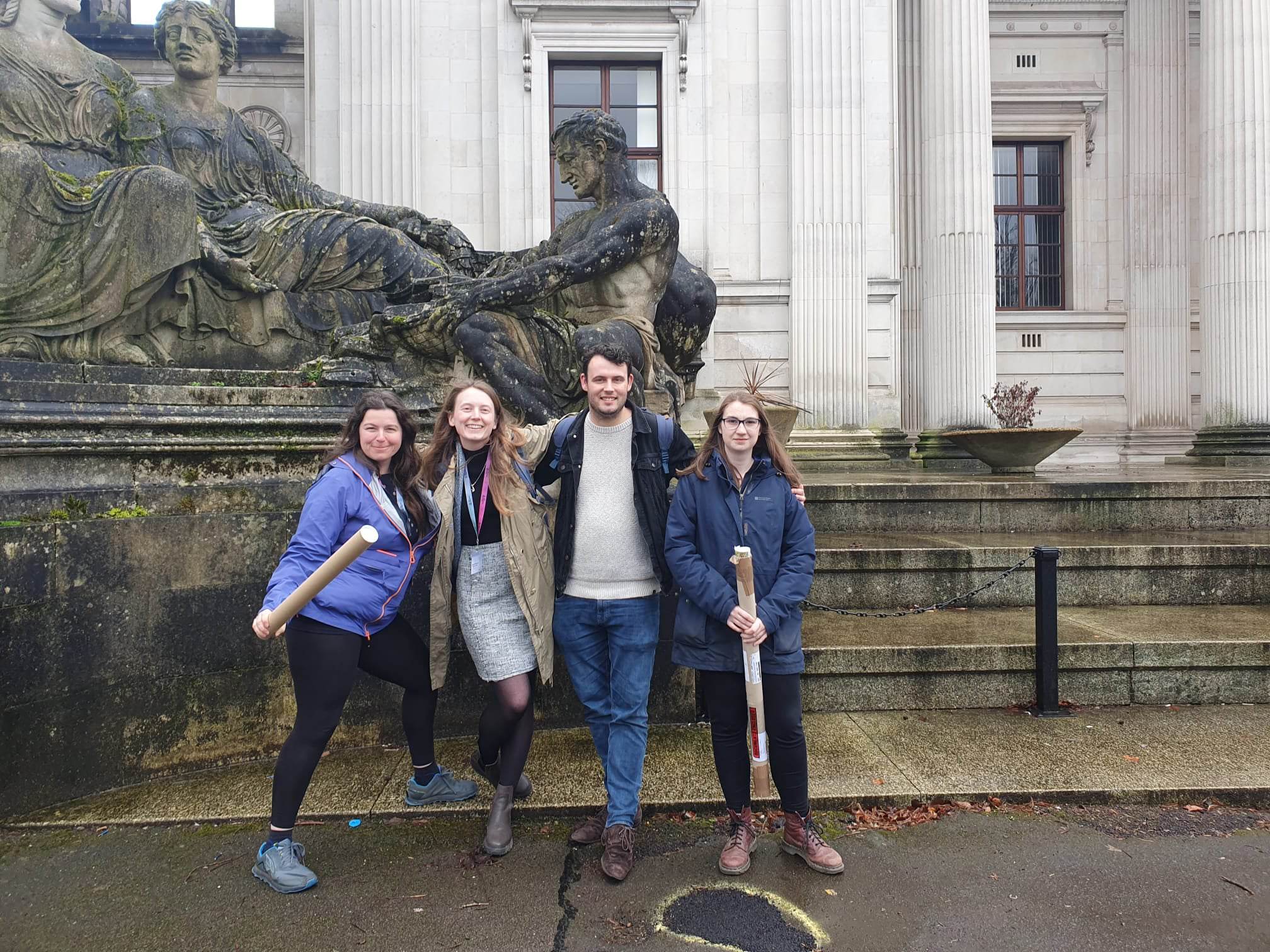 Photograph of four PhD students standing outside the Royal Entomological Society Student Forum 2023 in Cardiff