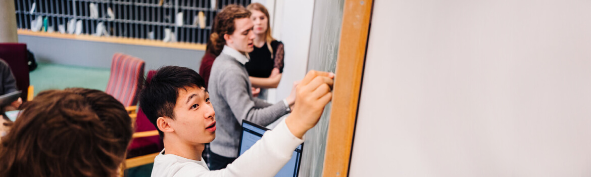 Students working at a chalkboard