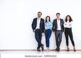 Stock image of four people standing against a wall