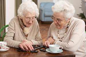 Elderly women playing dominos
