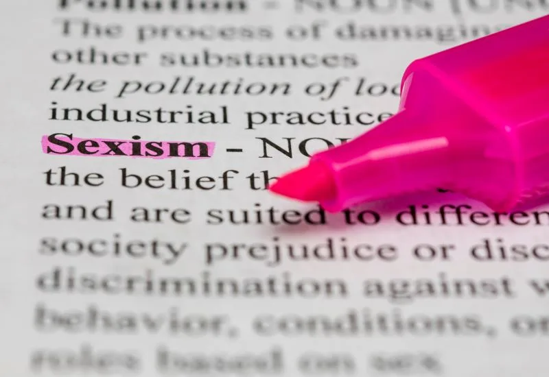 Sexism text in dictionary highlighted by a pink pen.