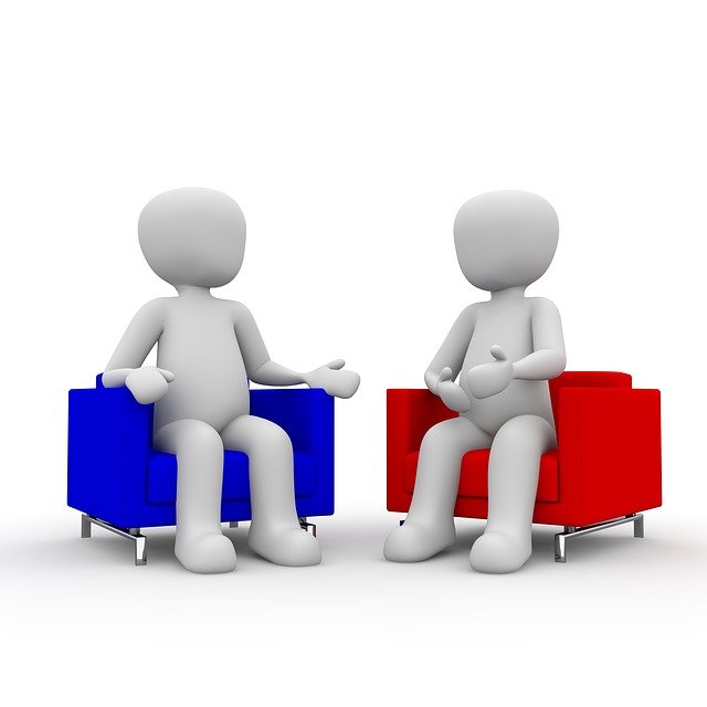 Image of figures sat on comfy chairs for a conversation