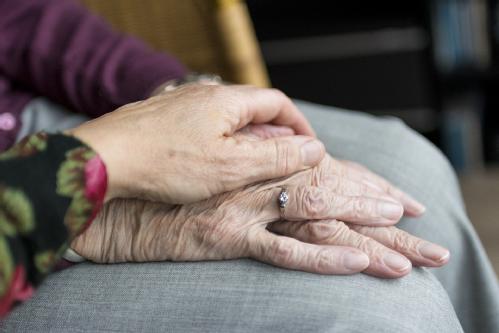 touching hands with an elderly person
