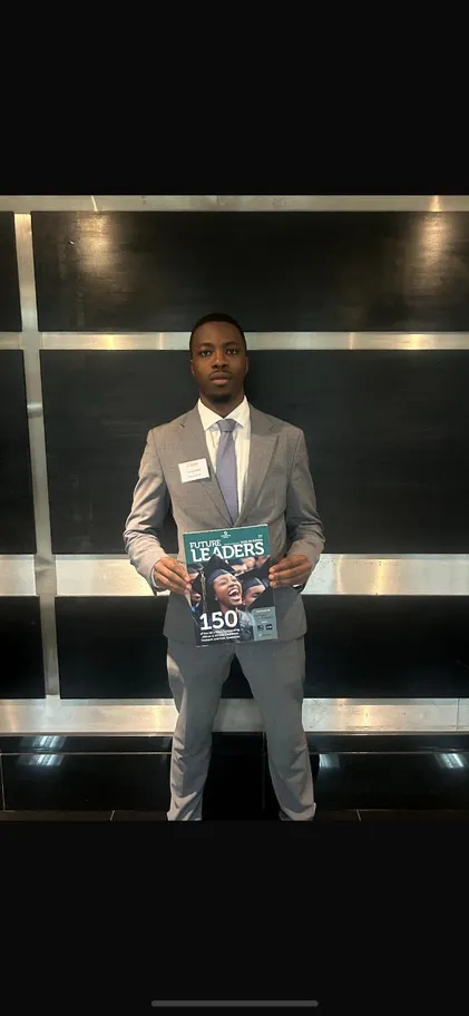 Image shows Sem Kohyrelon holding a copy of the Future Leaders publication.