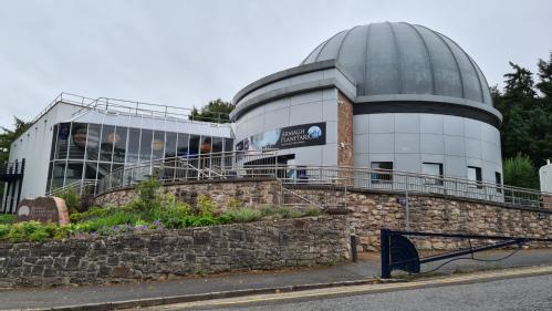 A large planetarium building with a prominent domed roof