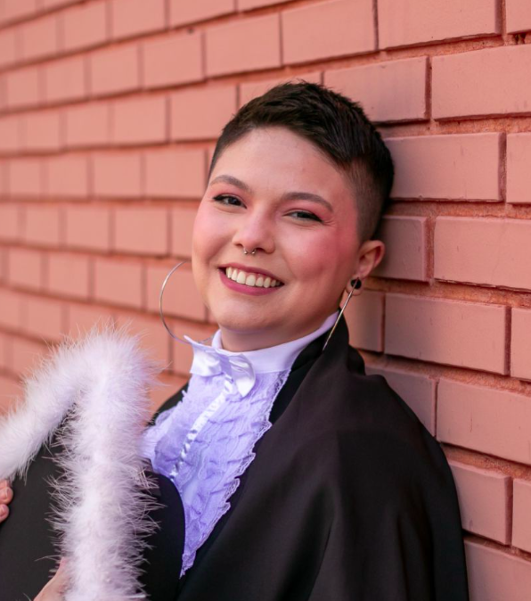 Picture of Gabriela holding its graduation cap.