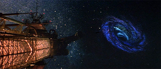 Screenshot from The Black Hole (1979) showing swirling gas lying beyond the starship Cygnus